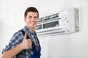 Technician in front of air conditioner